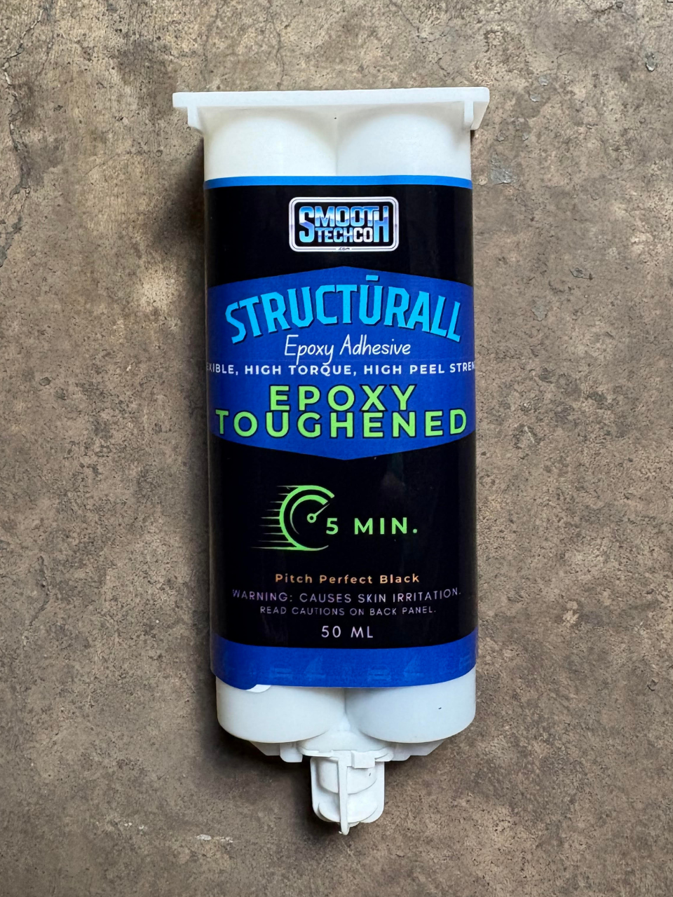 Epoxy adhesive container with 'SmoothTech' branding on a concrete surface