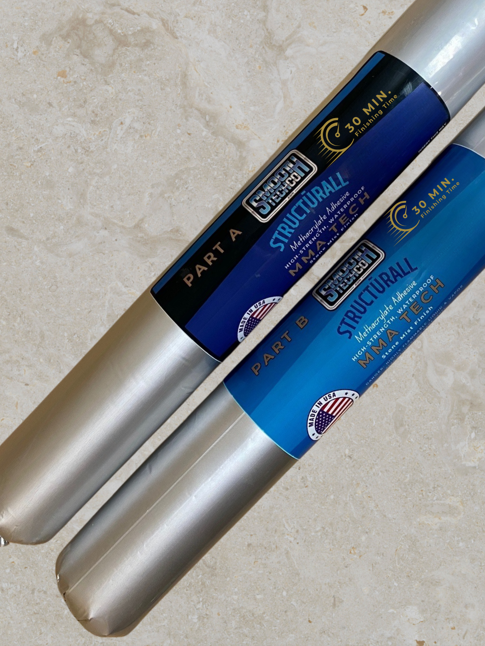 Two rolls of Structurlall MMA Ten Adhesive (sausages) on a beige background
