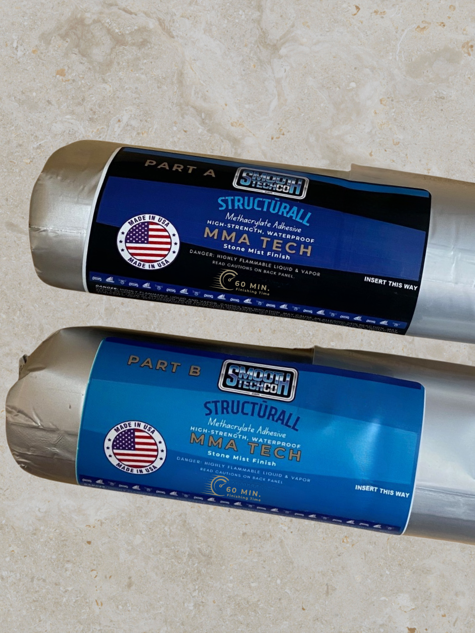 Two rolls of Structurlall MMA Twenty Adhesive (sausages) on a beige background