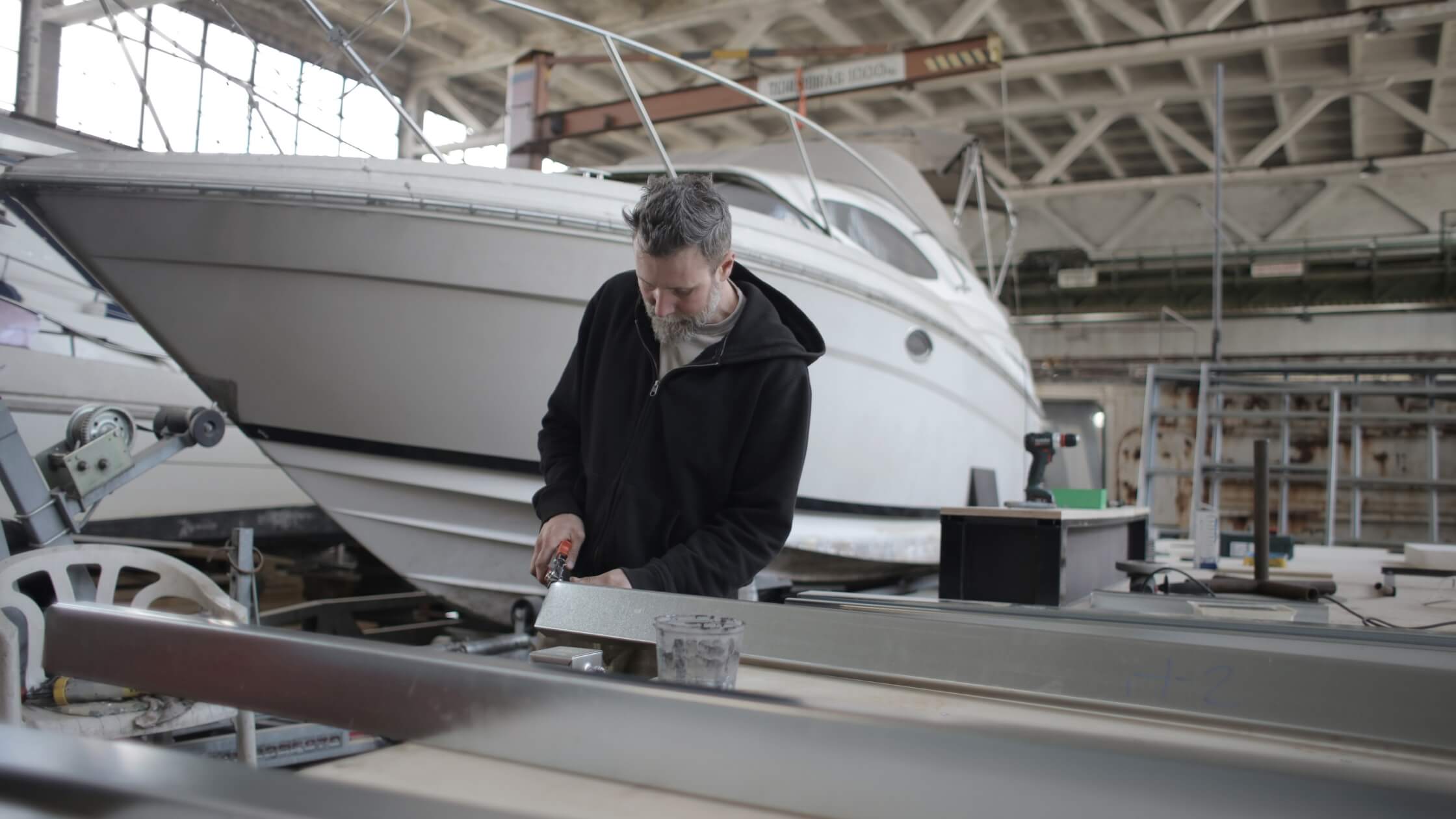 Testimonials background - man working on boat repair